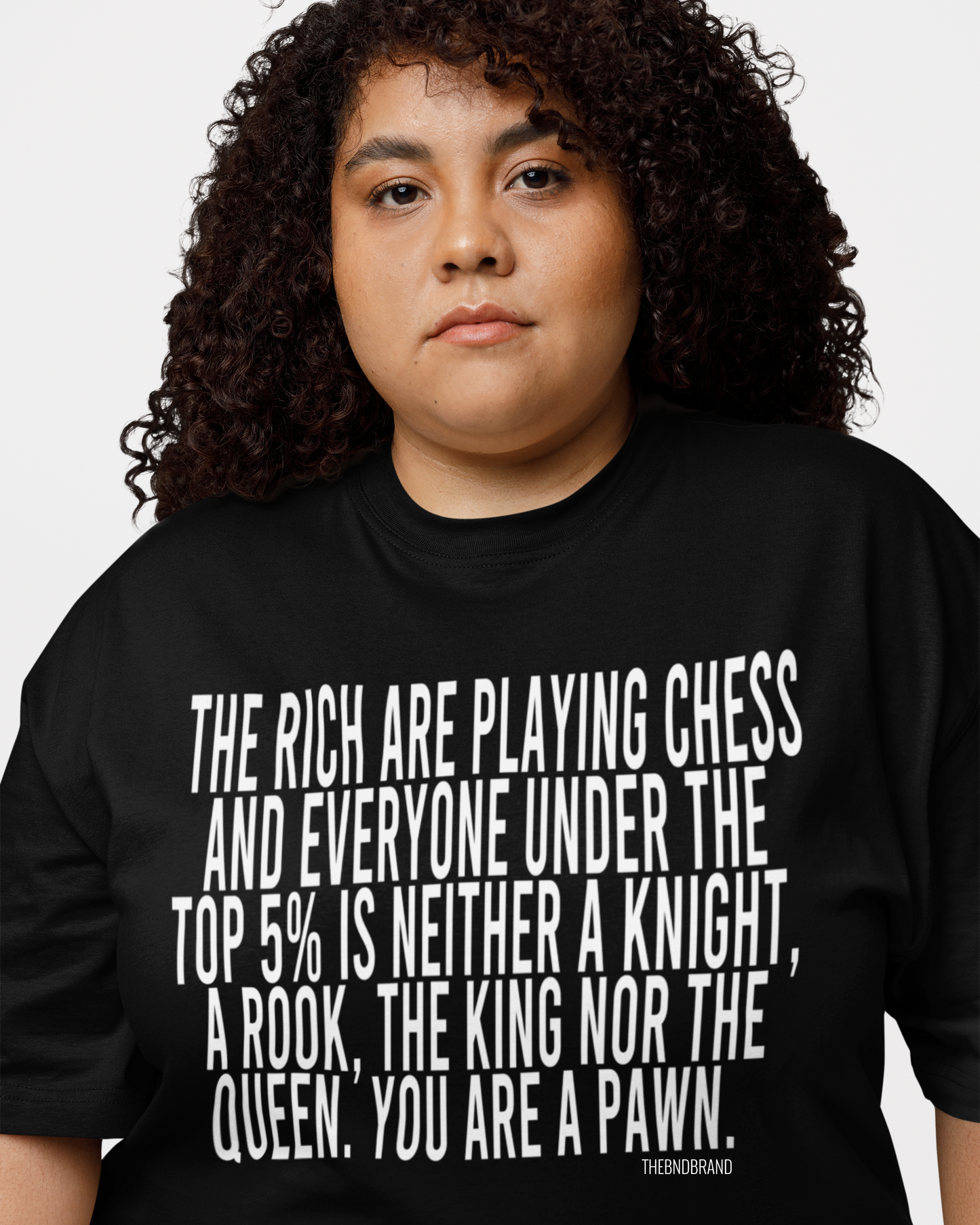 Person wearing a black t-shirt with a quote on it against a white background