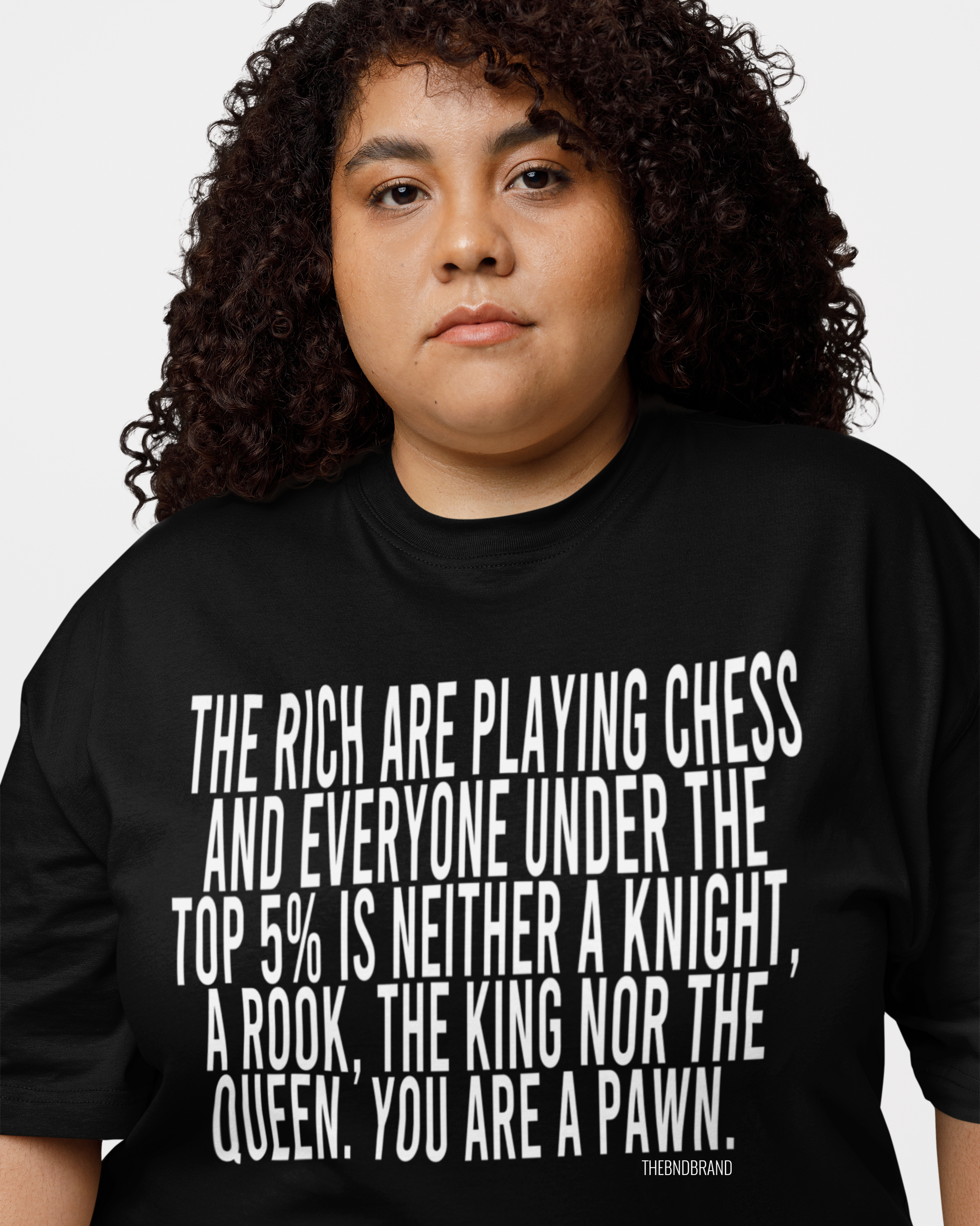 Person wearing a black t-shirt with a quote on it against a white background